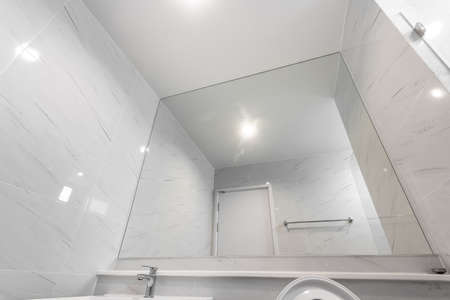 Close Up Large Mirror in White Marble Bathroomの写真素材