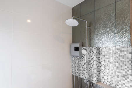 Shower and Water Heater in Bathroom, on Mosaic backgroundsの写真素材