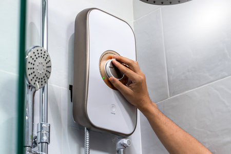Hand person with water heater control panelの写真素材