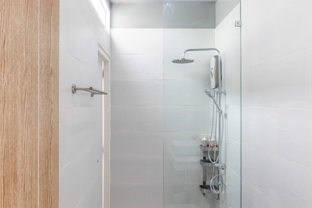 White Modern Bathroom with Shower Cabin and Tile Backgrounds  in Apartmentの写真素材