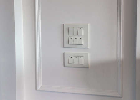 Close up forefingerâ€™s  is turning on or turning off the light-switch on stenciled wooden...