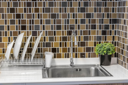 Close up of modern kitchen faucet and sink in kitchen roomの写真素材