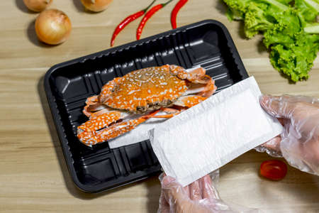 crab on plastic packaging with food absorbent in supermarket, Good quality for food storeの写真素材