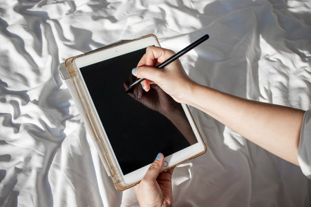 Businesswoman working at sea view hotel using tablet when traveling in Asia