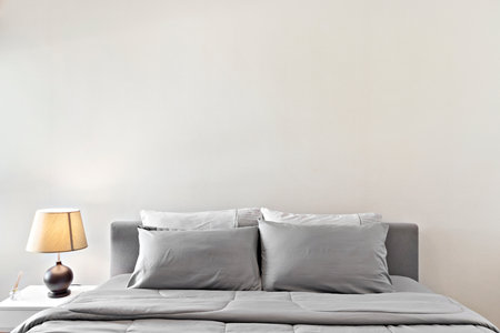 gray bed and lampの写真素材
