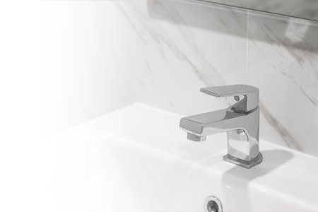 Clean sink with white light, concept of cleanliness and hygiene in the home.の写真素材