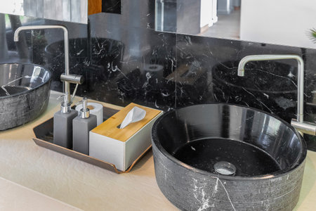 bathroom with black marble sink and marble wallの写真素材