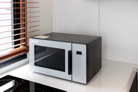 Microwave in a white kitchen of minimal houseの写真素材