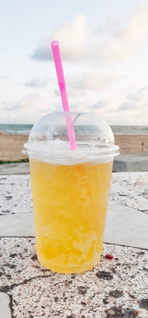 Thai-style beer, drink in glasses with ice, suck straws on the beachの写真素材