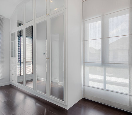 Modern white built-in wardrobe of bedroom interiorの写真素材
