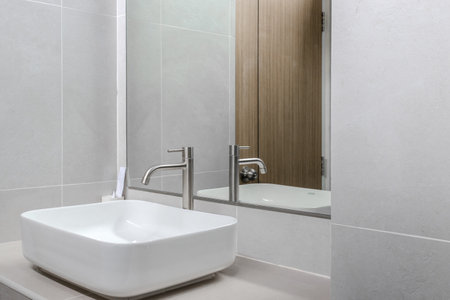 modern white sink that embodies cleanliness and contemporary design. The sinkâs smooth surface and minimalist aesthetic create a sense of elegance in any bathroom or kitchen settingの写真素材