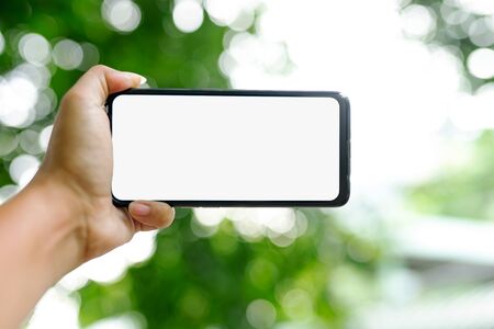 Smartphone images  white screens placed in green nature scenes