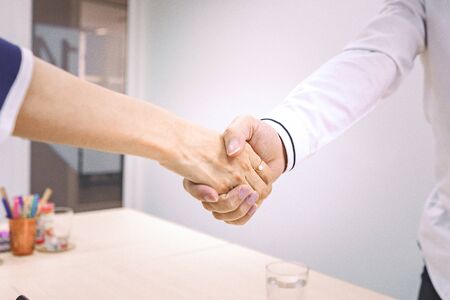 Business people shake hands to finish the meeting , Hand in hand to work togetherの写真素材