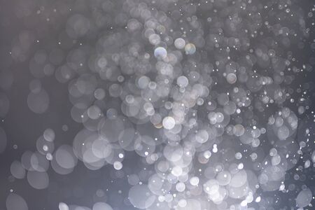 Abstract bokeh from light and water spray in backgrounds of various colors