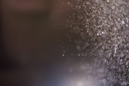 Abstract bokeh from light and water spray in backgrounds of various colorsの写真素材