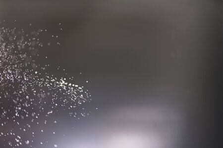 Abstract bokeh from light and water spray in backgrounds of various colorsの写真素材