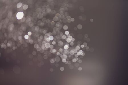 Abstract bokeh from light and water spray in backgrounds of various colors