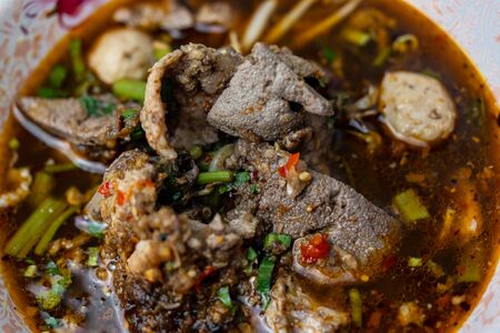 The close-up photos of the food name Tom Yum Pork noodles look very delicious.の写真素材