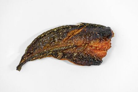 A close up of fried catfish in a white background