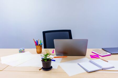 An office desk that has a computer, a notebook and a pen.の写真素材