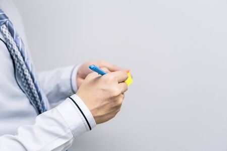 A business person is holding a pen and notes on the assignmentの写真素材
