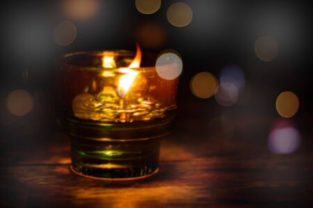 Abstract blurred  oil lamp with golden bokeh light  for backgroundの写真素材