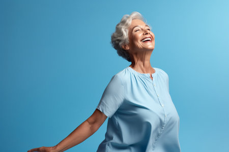 elderly woman happy dance on bokeh style warm backgroundの素材