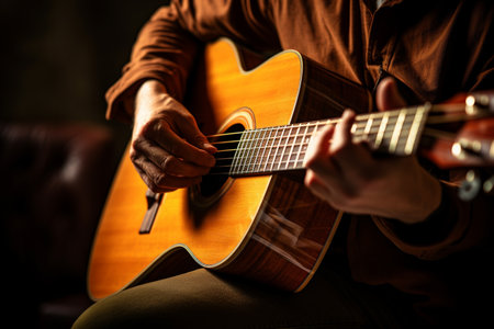 close up of hands playing an acoustic guitar bokeh style backgroundの素材