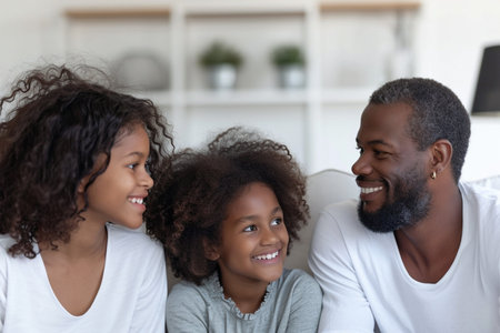 an african family sitting in living roomの素材