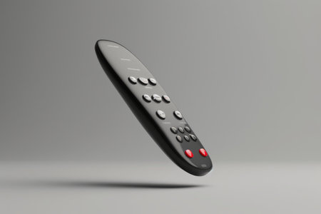 A remote control is shown in a white background. The remote control is black and has a red button on the top leftの素材