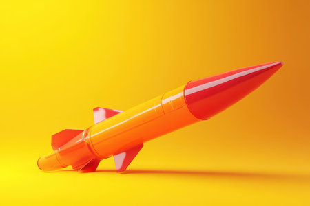 A red and orange rocket is on a yellow background. The rocket is in a position that makes it look like it is about to launchの素材