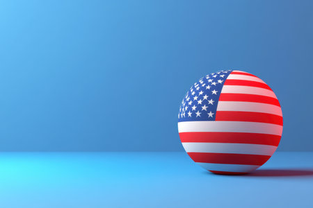A red, white, and blue ball with the American flag on it. The ball is sitting on a blue backgroundの素材