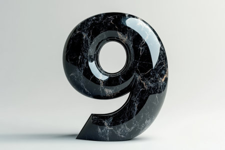 A black marble with a hole in the middle and the number nine on it. The marble is shiny and has a unique designの素材