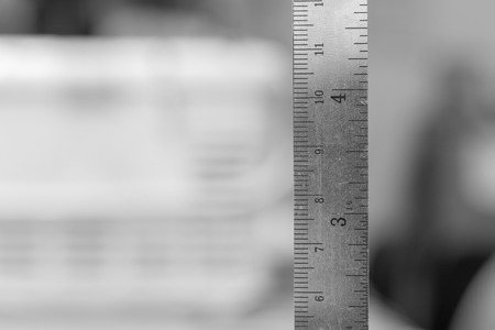 stainless steel ruler with blurry white backgroudの写真素材