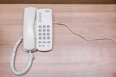 Home telephone with wooden background