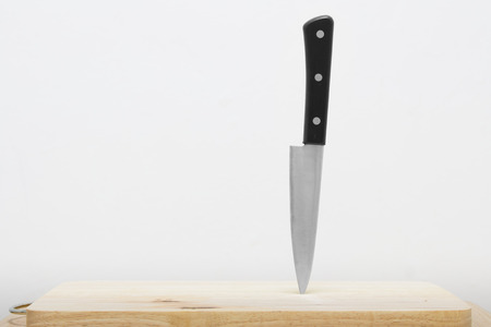 Knife on the cutting board with white background