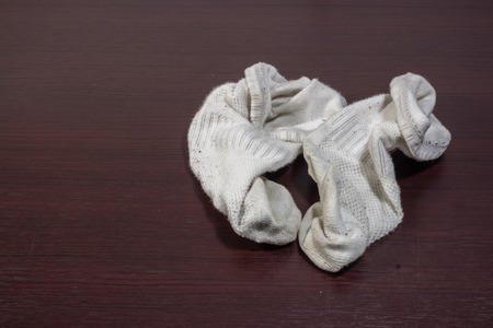 Used dirty socks on wooden floor