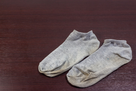 Used dirty socks on wooden floorの写真素材