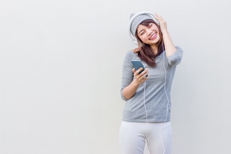 Asian woman listen to music with white headphoneの写真素材