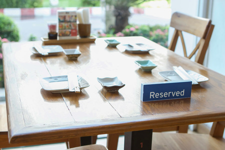 reserved sign on table inside restaurant