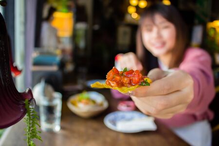 hand holding chip and salsaの写真素材