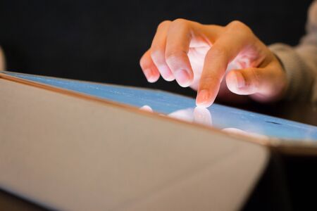 Person hand typing on tabletの写真素材