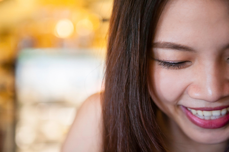 Half face of happy asian woman in close upの写真素材