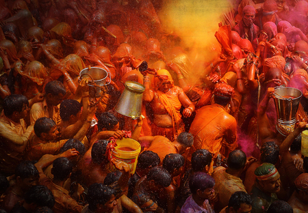 MATHURA,INDIA - 7/03/2015 : Indian devotees dance in colored water at the end of Holi celebrations, the Hindu festival of colors at the Baldev Temple.のeditorial素材
