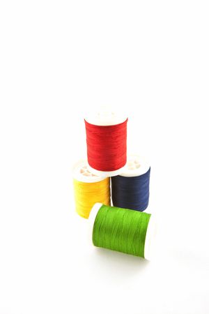 four multicolored spools on a white background