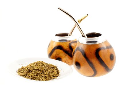 couple of mate cups on and a plate with mate a white background
