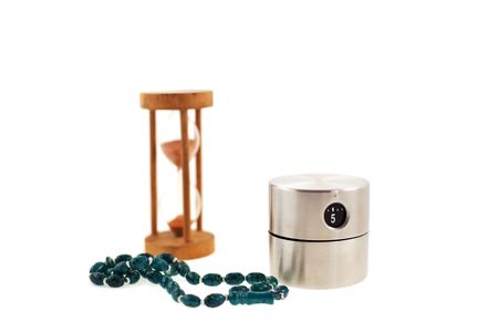 modern timer, old sandglass and bead on a white background