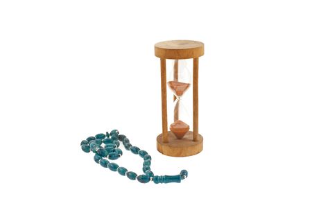 old sandglass and bead on a white background
