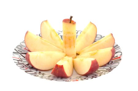 chopped red apple on a dish. white backgroundの写真素材