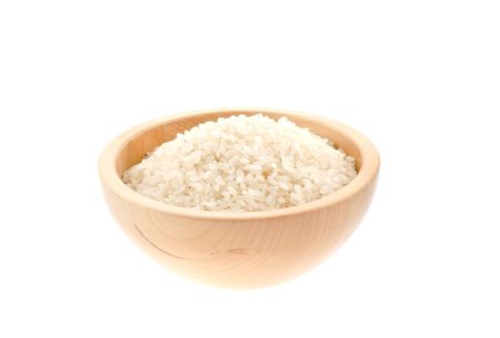 rice seeds in a wood bowl. white backgroundの写真素材